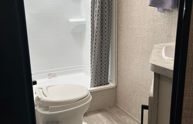 Bathroom with extra large shower, towels, wash clothes, RV toilet paper and hand soap