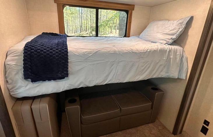 Bunk Room.  Top bunk, Jack-knife sofa, and additional fold out mattress for floor.  Window coverings have been added to all windows in bunkroom.