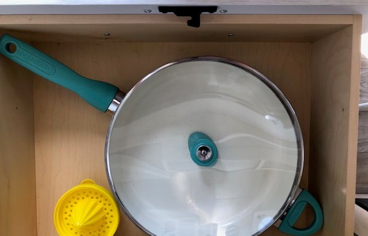 kitchen storage with large covered saucepan