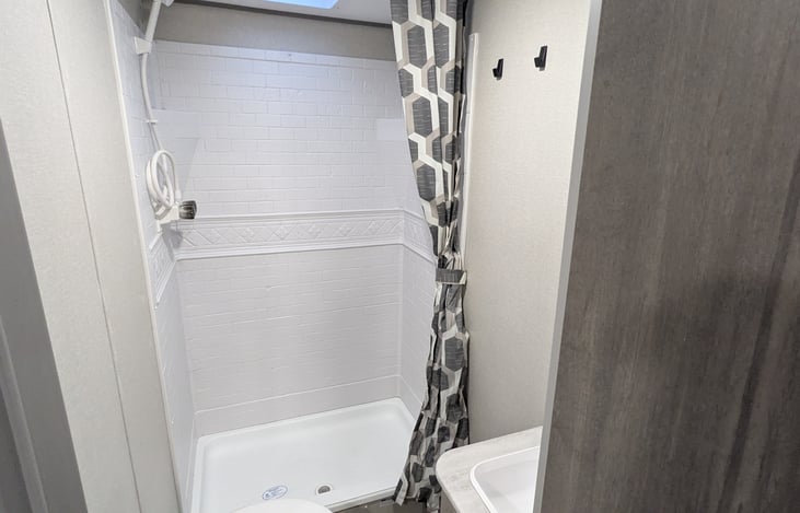 Walk in shower in rear bathroom.