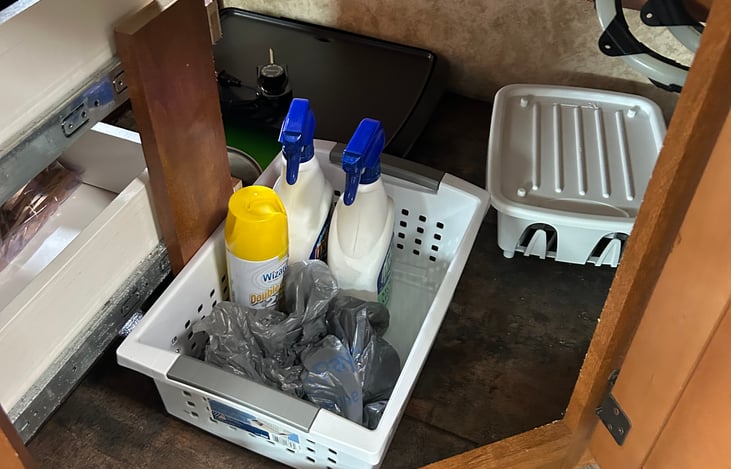 Cleaning supplies if needed, dish drying rack, back left is a griddle.