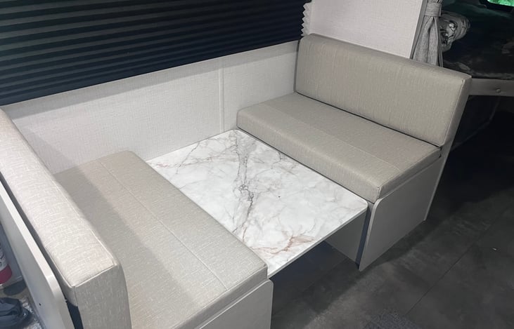 Table top dropped down for traveling. Lots of storage underneath each bench. Great for storing food while towing.