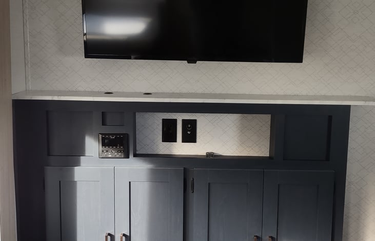 42 inch smart tv and entertainment center that includes aux port, usb, bluetooth and more