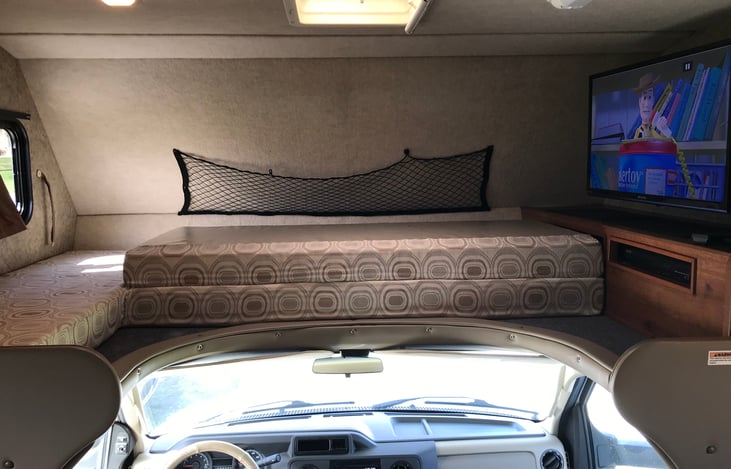 Cab over bed in the folded up position for traveling.