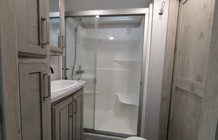 Experience a spa-like retreat with a walk-in shower, porcelain toilet, and spacious vanity. Large medicine cabinets provide ample storage, making this private master ensuite a true luxury upgrade.