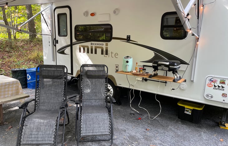 Outdoor table, grill, and a plug to operate the cooktop or air fryer.