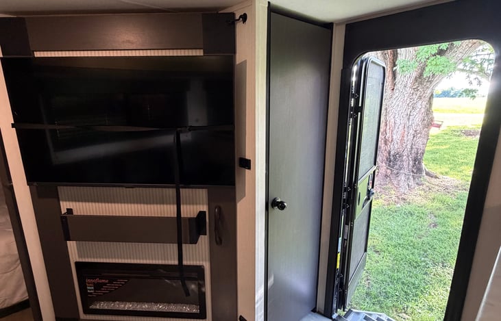 55 inch tv with fireplace, storage behind the tv, and dry goods cabinet