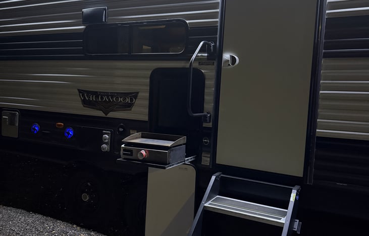 Outdoor lighting, awning, and flat top grill for your convenience.