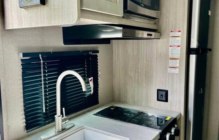 Sink, 2-Burner Stove, Microwave, Roomy Fridge with separate Freezer. We supply your dishes, pots and pans, linens, basic spices and basic paper goods.