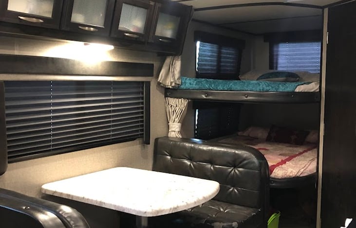 Table with bunkbeds in the background, table can make into a bed.