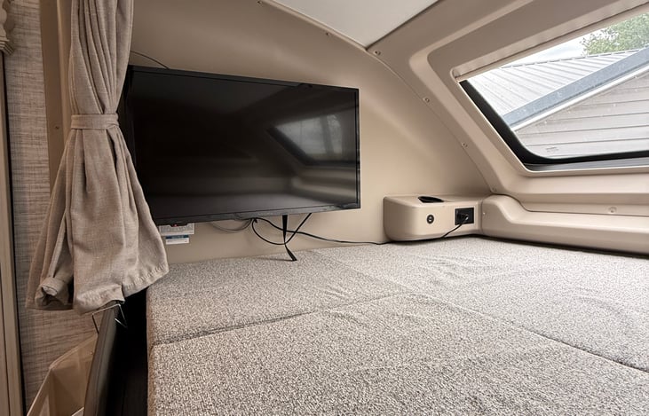 Large smart TV with option to swing out for better viewing from the cabin.