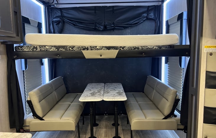 Queen top bunk, dinning area turns into queen bottom bunk.