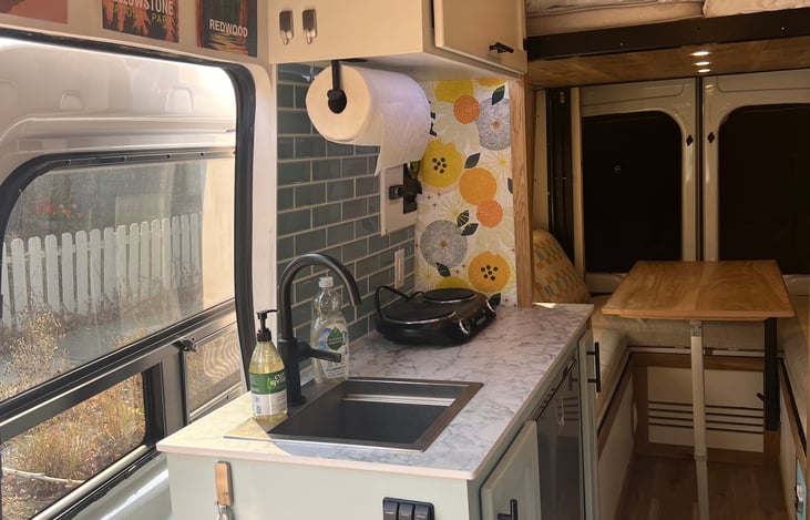 Fully outfitted Kitchen with sink, fridge, stovetop, dishes, cookware, silverware, french press, pour over, coffee cups, wine glasses and more!