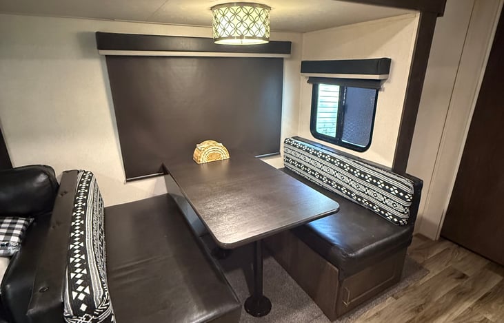 Custom cushions on kitchenette dining table. Can be converted into extra sleeping bed.