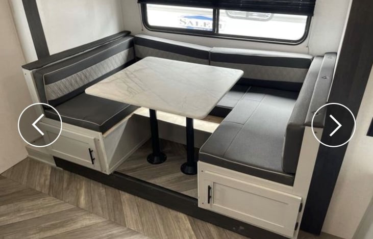 Slide out dining area and another large bed. Lots of storage underneath and big enlargement of Kitchen and living area.