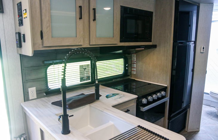 Full kitchen stove, sink , refrigerator, and pantry. Plenty storage space.