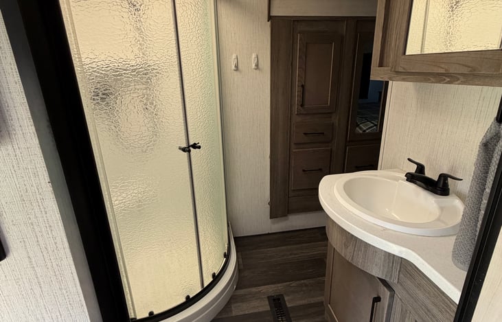 A thoughtful layout makes vacation living easier! Access the bathroom from either the hallway or the private queen bedroom.