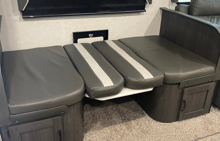 Dining room table converts into a bed