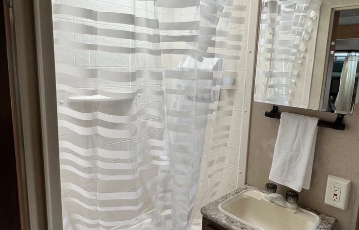 Stand up shower with tub.