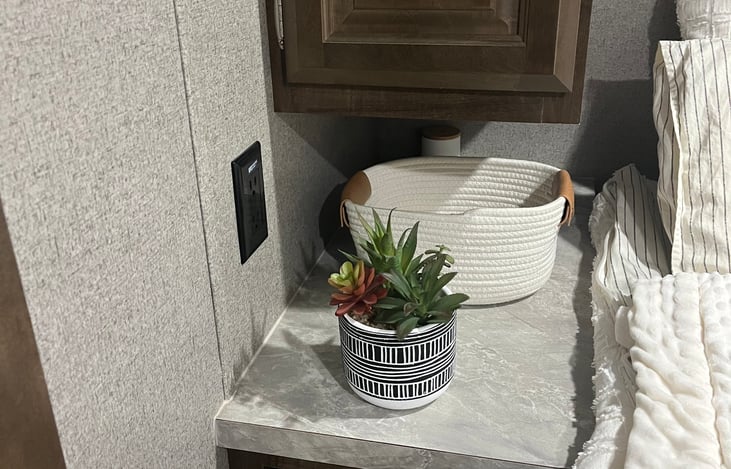 Nightstands with plugs on each side of the bed