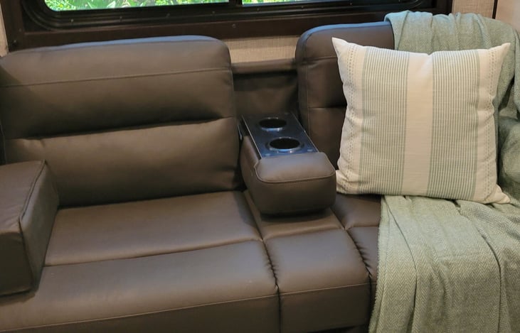 Fold down armrest with build in drink holders.  This couch also folds into a bed.