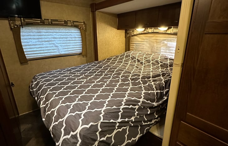 Slide out queen bed with two inch memory foam mattress topper, water proof mattress cover and luxury linens.