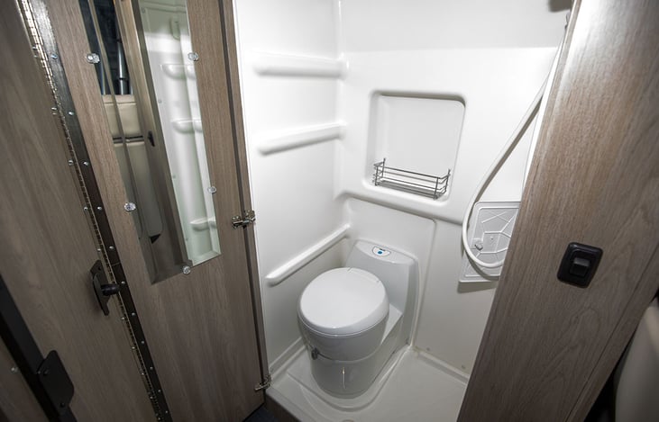 Cassette toilet swivels to provide more legroom with door shut.