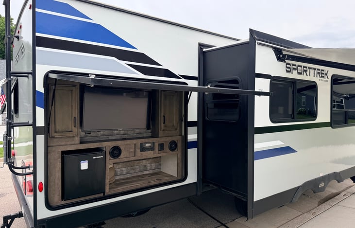 Outdoor television and entertainment center with refrigerator and prep area Bringing luxury entertainment to the outdoors.