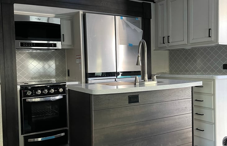 Full size residential fridge, four burner cook top too.