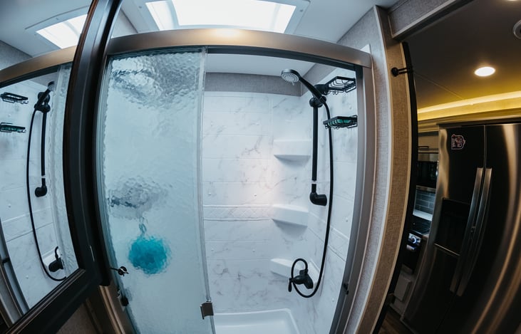 Nice roomy shower with plenty of head room.  On demand hot water from the tank-less water heater.