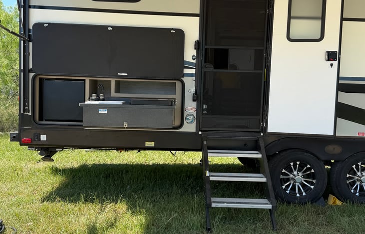 Outdoor Kitchen area.  Refrigerator, Sink, and 2 burners.