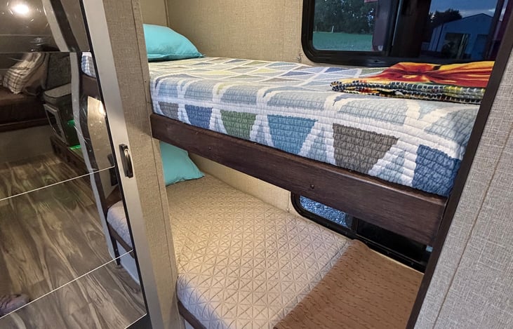 Bunkhouse (storage at foot of both beds & below bottom bunk mattress) - bathroom entrance