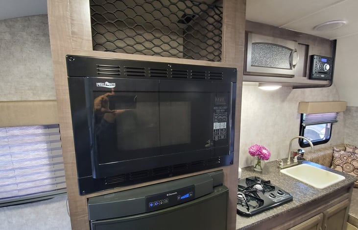 Full size microwave. you will need electric hookups or the generator to use.