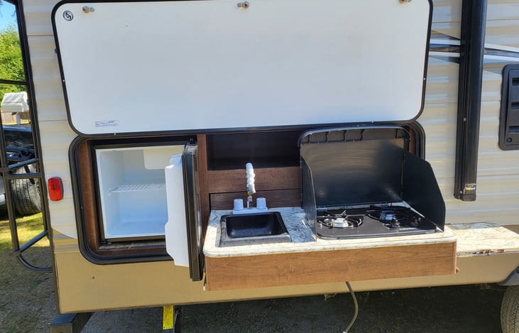 Outdoor sink, stovetop, and fridge
