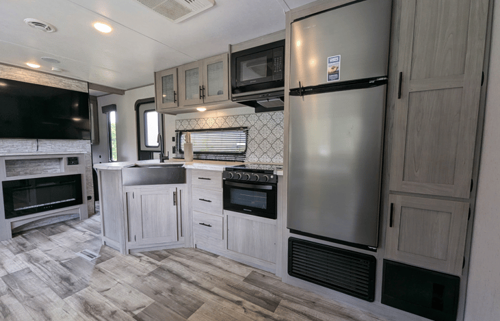 Bright, spacious and modern interior with large, well-equipped kitchen. Features two large slide-outs, ample storage throughout, electric fireplace, large TV, private bedroom, rear bunkhouse and more.