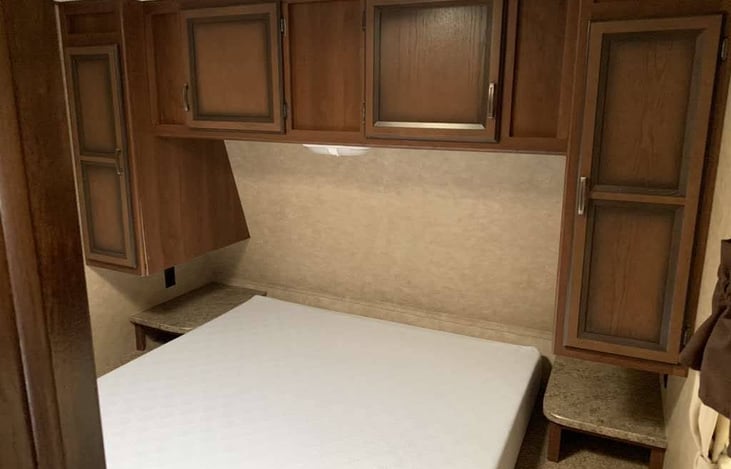 Queen bed with sliding door to room for privacy. Lots of closet space and bed is hinged with storage underneath.