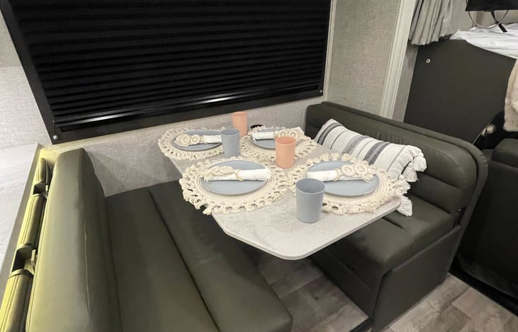 This dinette also turns into a sleeper.  It has 4 seat belts and two car seat hooks.  This can also fit two children or one adult.