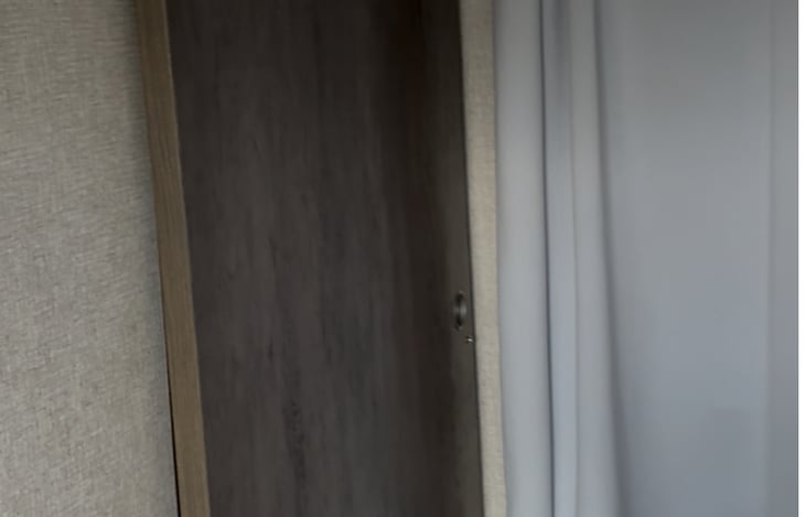 A sliding barn door divides the primary bedroom from the rest of the space.