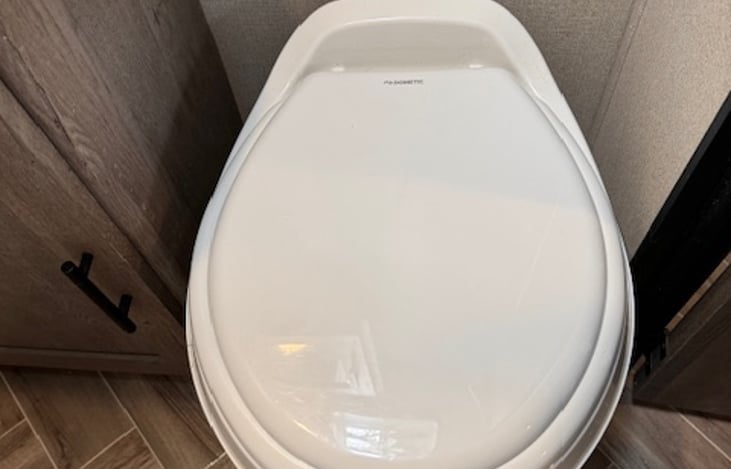 RV toilet flushes with a foot pedal on the bottom right.