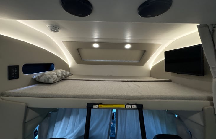 Sizeable Queen size bunk over the driver's seat - accent lights and your own TV!!