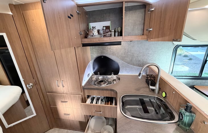 Comes with kitchen utensils plates spoons knives pots and pans with basic condiments. Keurig coffee maker is available per request with no additional charge.