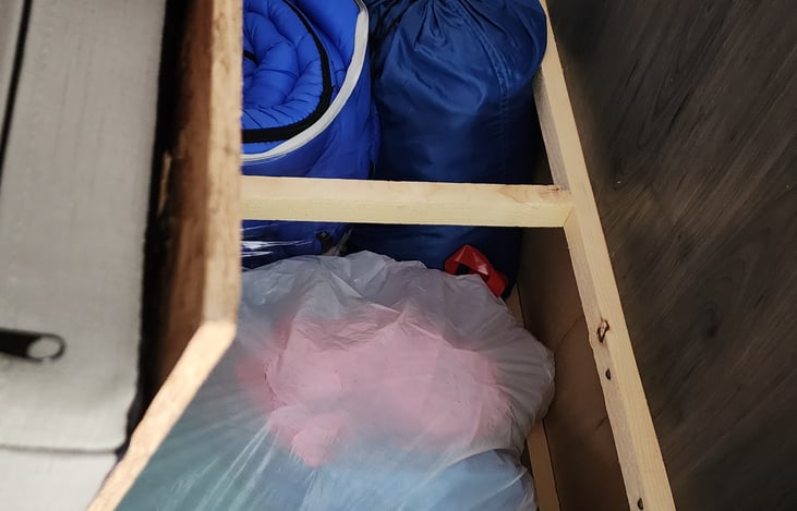 Sleeping bags and rafts under one seat and supplies under the other