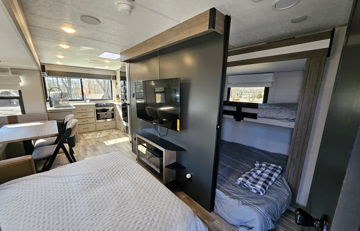 View into bunkroom with couch made into bed