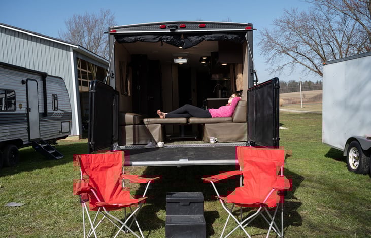 Relaxing on the convertible table/bed soaking up the sun.  Porch/Deck in place with railing on sides.  Steps to use onto porch