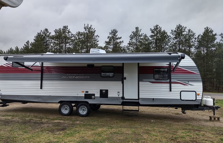 side view of camper with awning extended