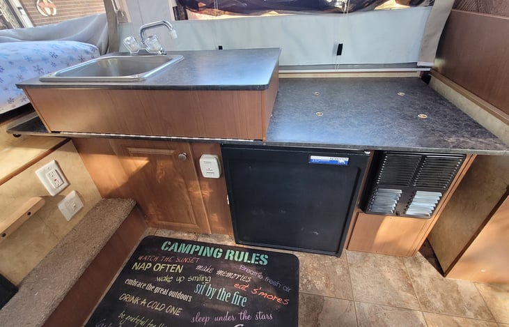 Sink, Fridge and space to connect stove inside camper next to sink