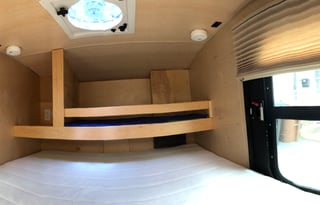 Cozy off-the-ground sleeper with kitchen