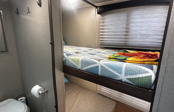 Bunkhouse (storage at foot of both beds) and bathroom entrance