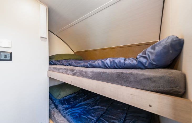 We have had a 6" 300lb guy stay 3 nights in these bunks. They are BIGGER than they look and offer a nice memory foam mattress PLUS freshly cleaned sleeping bags, big ones!