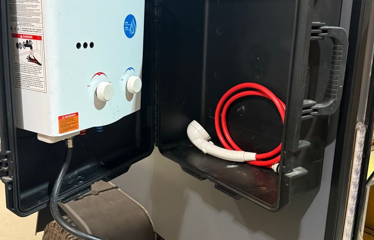 On demand hot water heater & 15 gal fresh water tank.